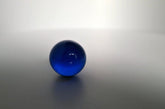 Glazen donker blauwe bol met diameter 25 mm.
